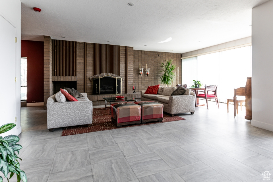 Living room with healthy amount of natural light and a brick fireplace