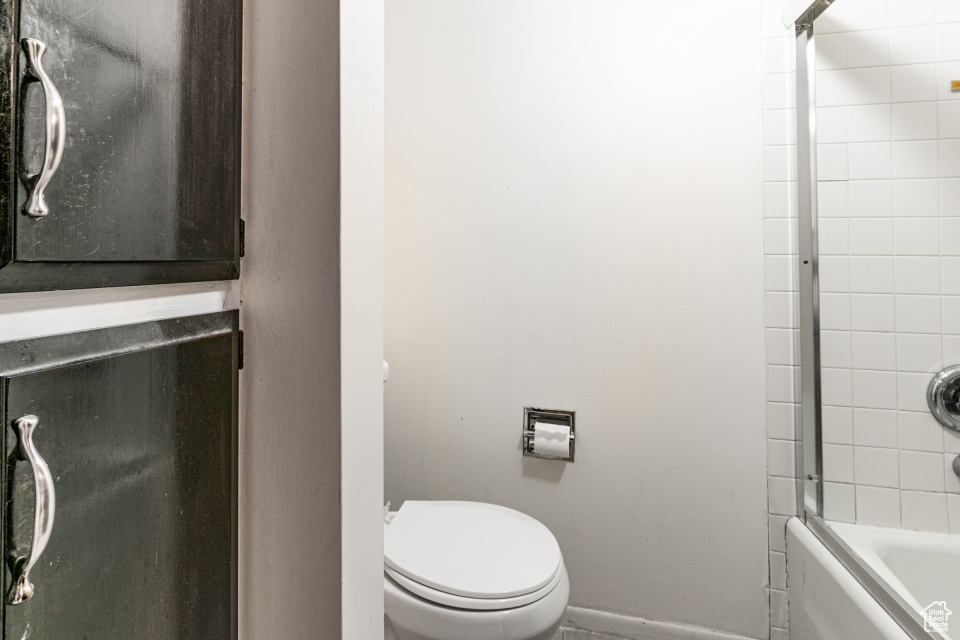 Bathroom featuring baseboards and washtub / shower combination