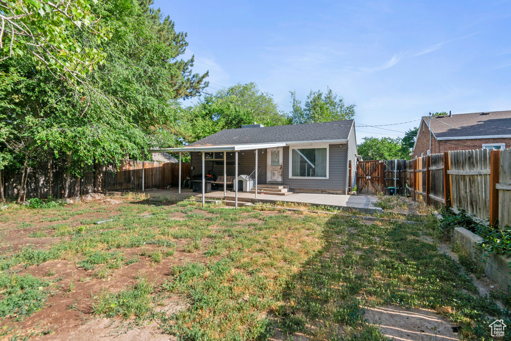 Back of property featuring a patio and a fenced backyard