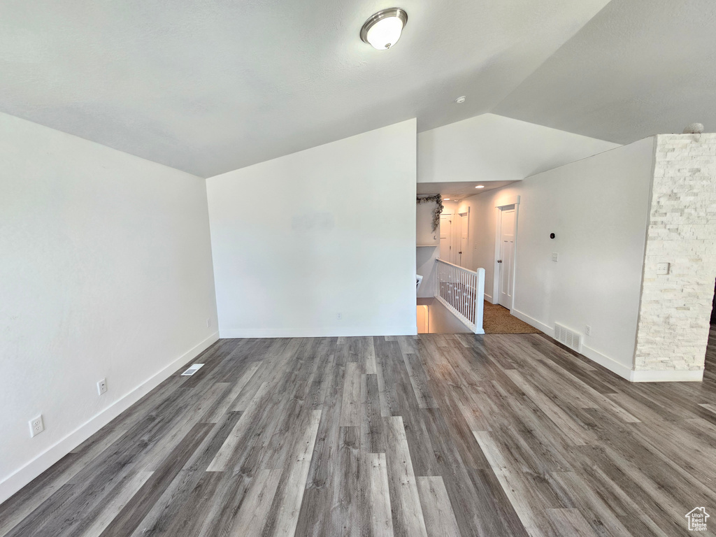 Additional living space featuring lofted ceiling and wood finished floors