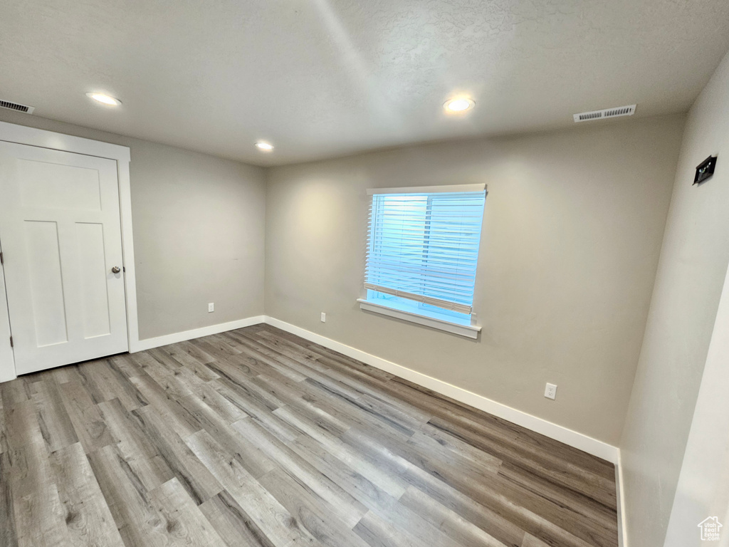 Empty room with recessed lighting and wood finished floors