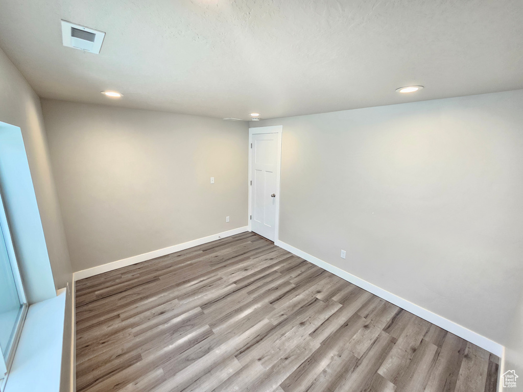 Spare room featuring wood finished floors and recessed lighting