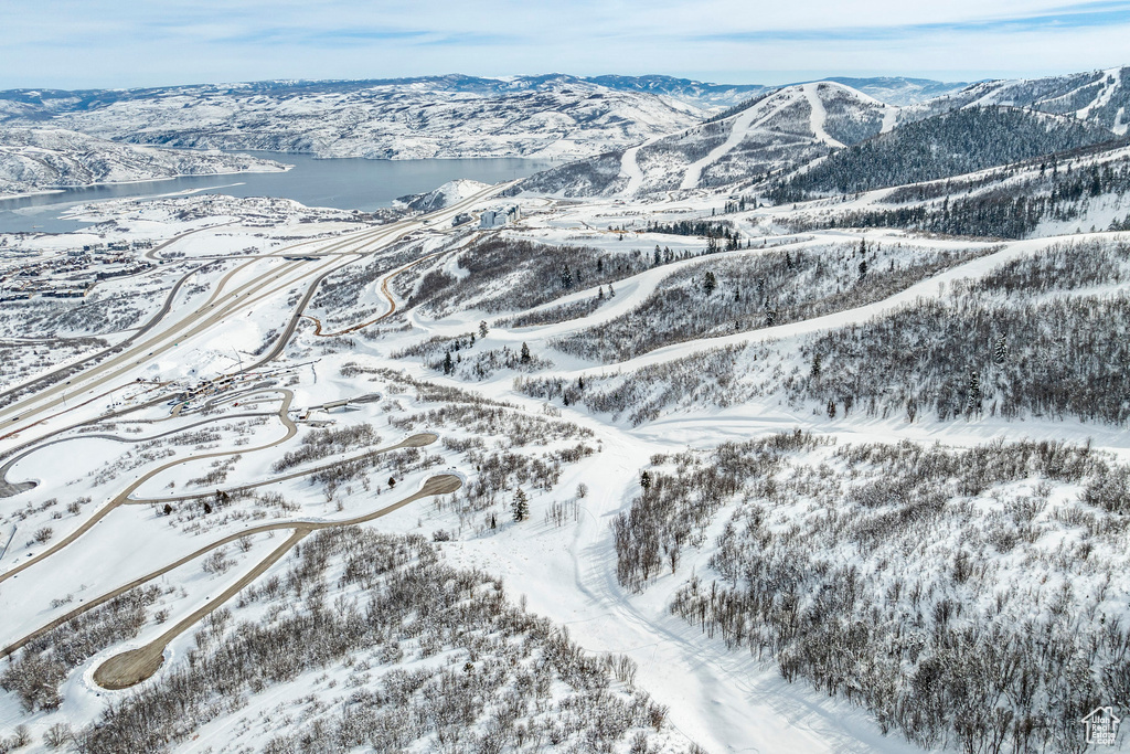 Snowy aerial view featuring a mountain view