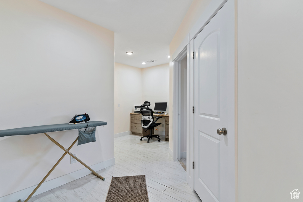 Hallway with an office area and recessed lighting