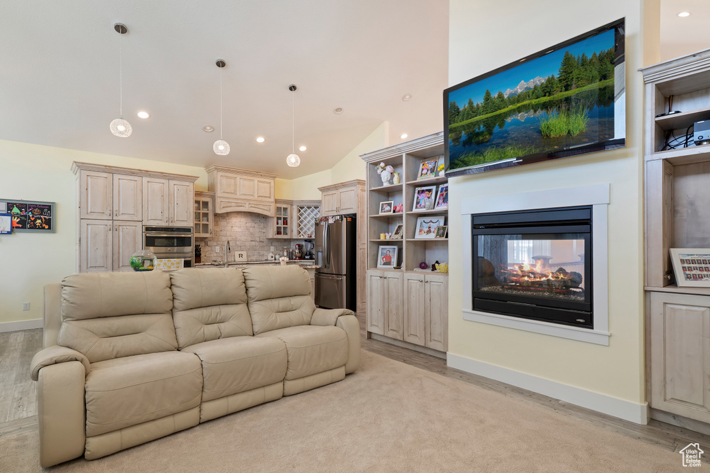Living area featuring recessed lighting, a multi sided fireplace, and high vaulted ceiling