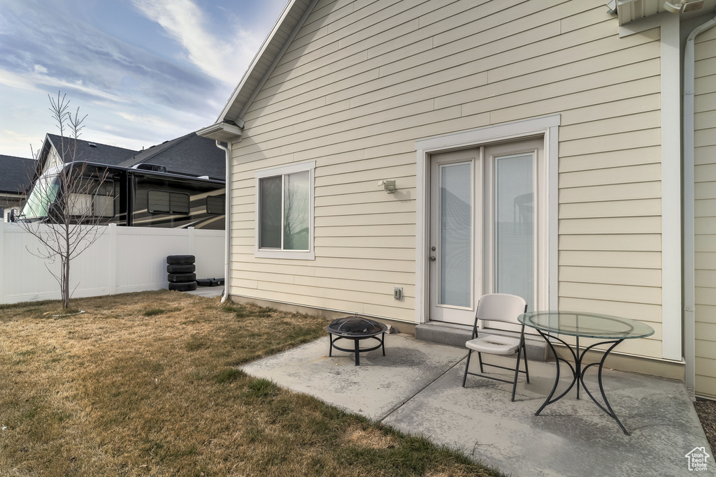 Rear view of property with a fire pit and a patio area