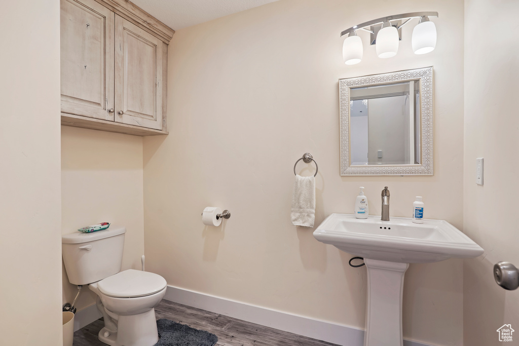 Bathroom featuring toilet and wood finished floors