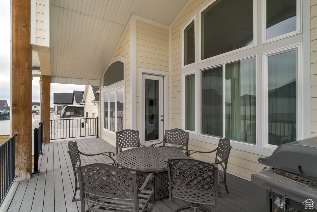 Deck featuring outdoor dining area and a grill