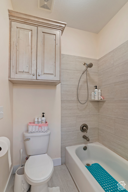 Full bathroom with toilet and shower / tub combination