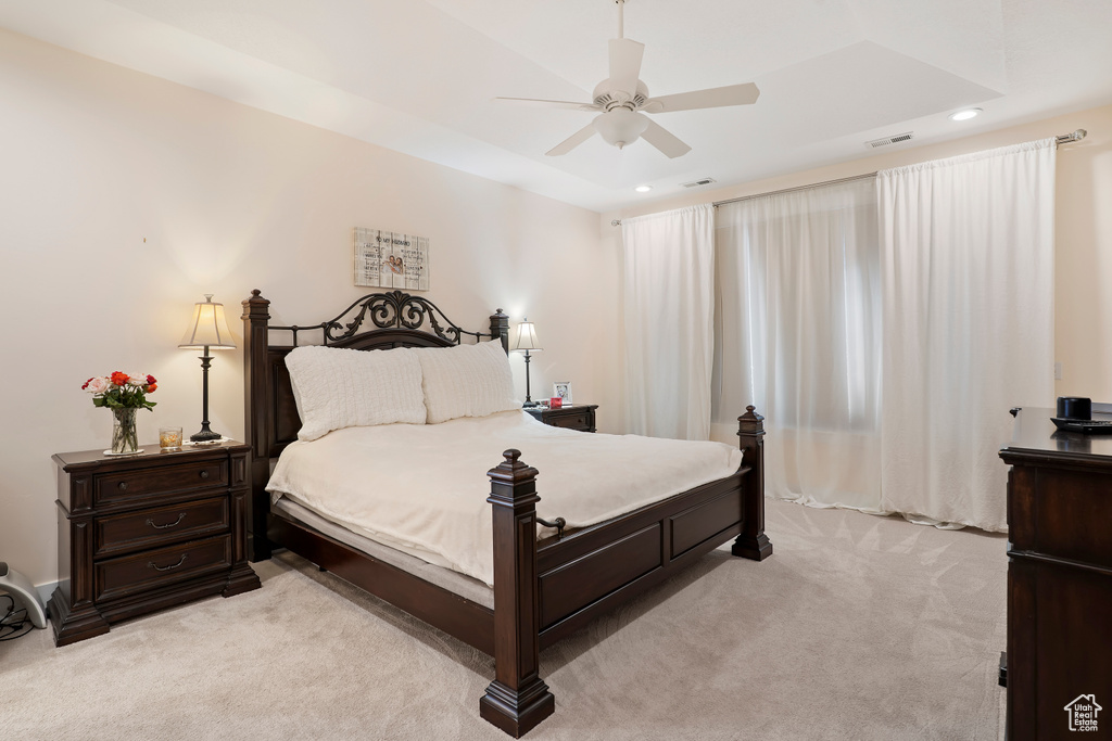 Bedroom with light carpet, recessed lighting, and a ceiling fan