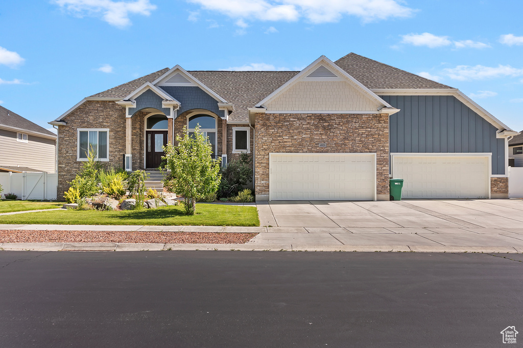 Craftsman-style home featuring a garage and concrete driveway