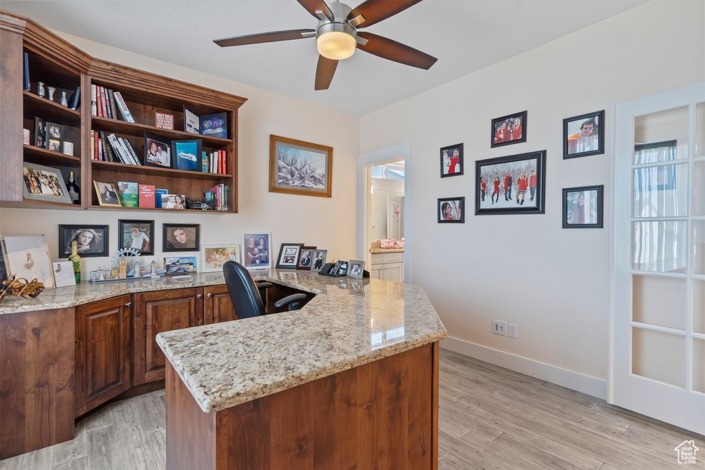 Office space featuring ceiling fan and light wood-type flooring