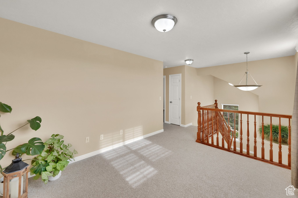 Unfurnished room featuring baseboards and carpet
