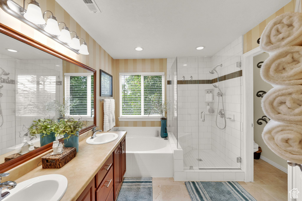 Full bathroom with a shower stall, a garden tub, double vanity, tile patterned flooring, and recessed lighting
