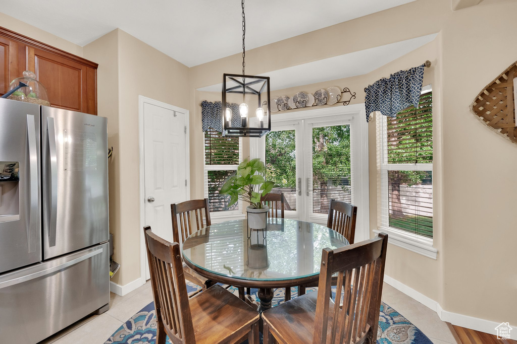 Dining space with a chandelier and light tile patterned flooring