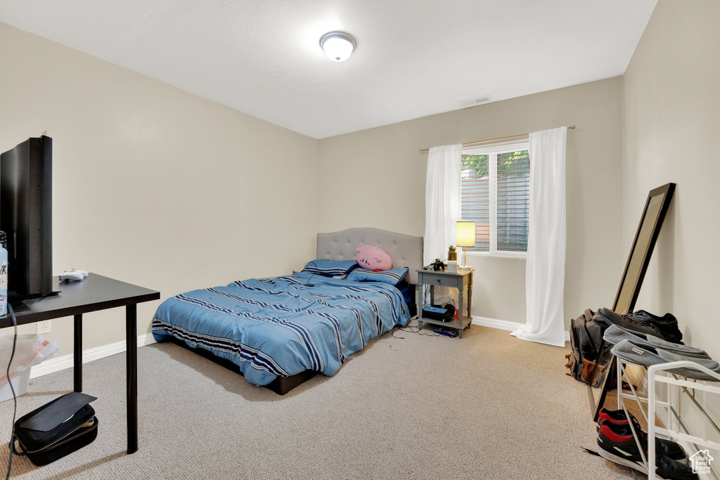 Bedroom featuring carpet floors and baseboards