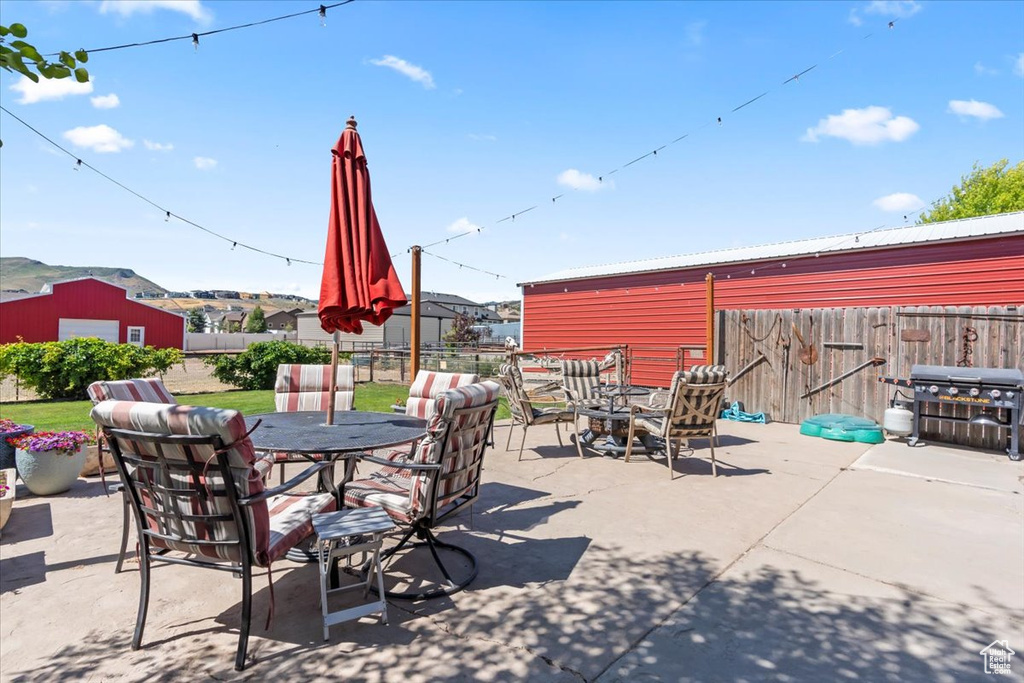 View of patio featuring area for grilling and outdoor dining space