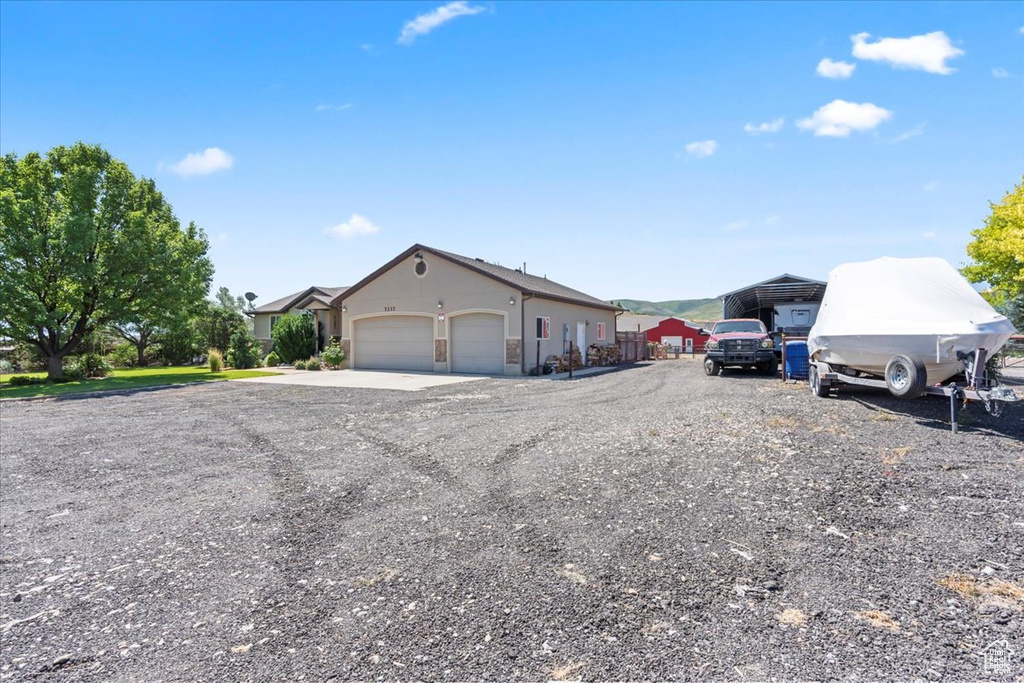 View of front of home with an attached garage and driveway