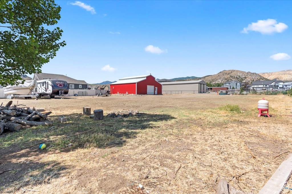 View of yard featuring a mountain view, an outbuilding, and an outdoor structure