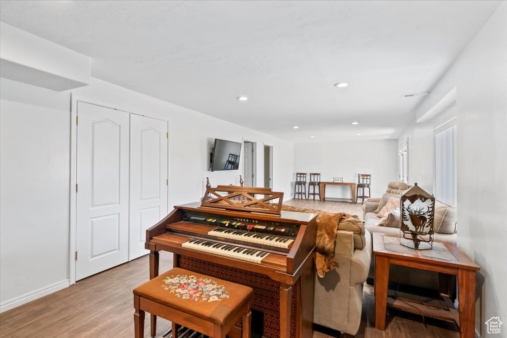 Living area with wood finished floors and recessed lighting
