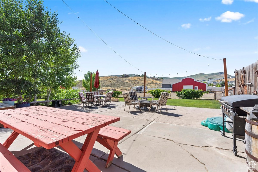 Fenced backyard with outdoor dining area, a patio, and grilling area