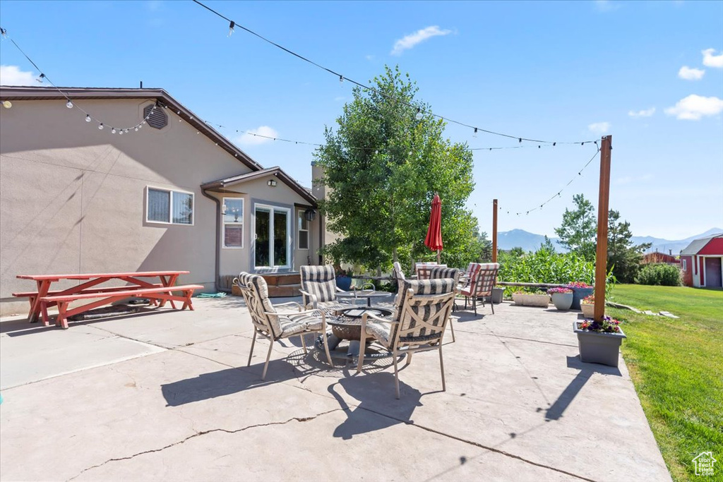 View of patio / terrace with an outdoor living space with a fire pit and a mountain view