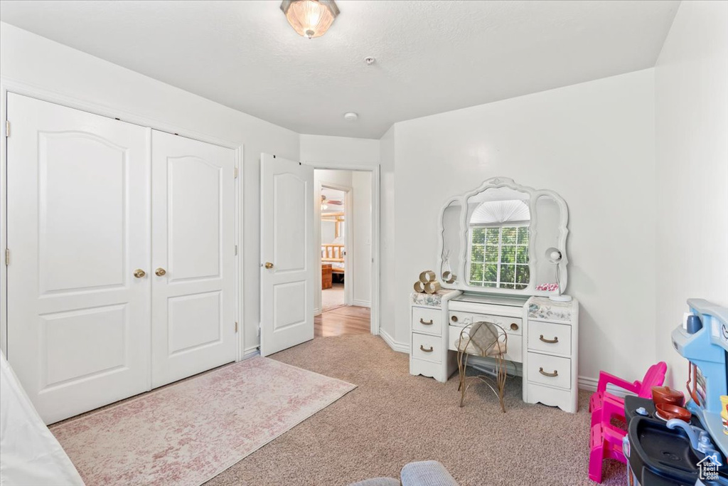 Bedroom featuring carpet and a closet