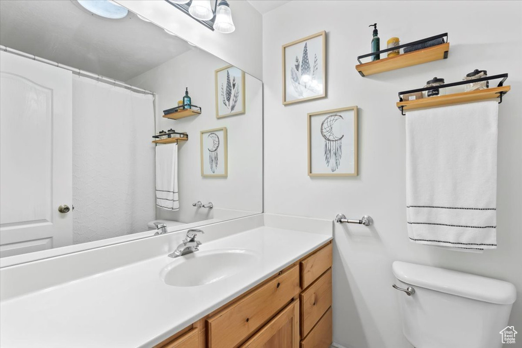 Full bath featuring toilet and vanity