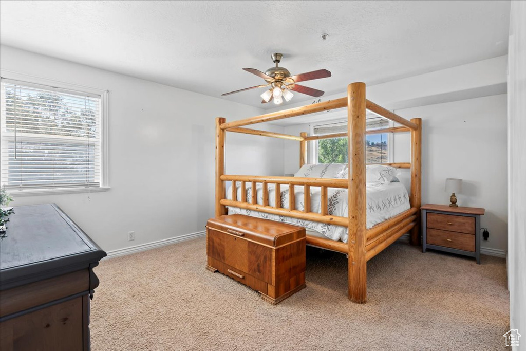 Bedroom featuring light colored carpet and ceiling fan