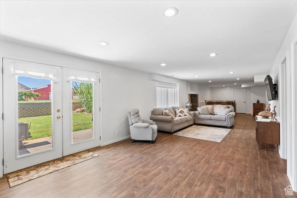 Living area featuring wood finished floors, french doors, and recessed lighting