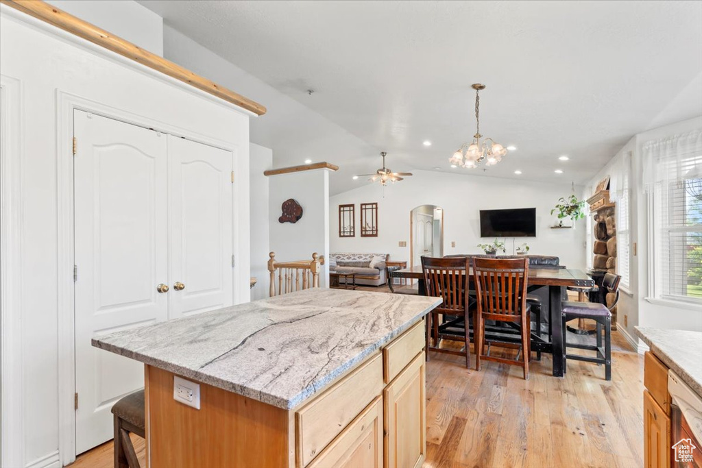 Kitchen featuring arched walkways, open floor plan, light wood-style floors, recessed lighting, and a ceiling fan