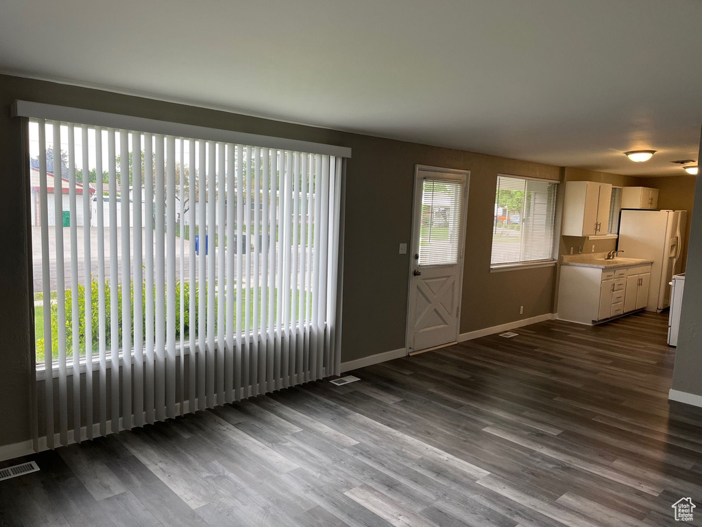 Unfurnished living room with dark wood-style floors