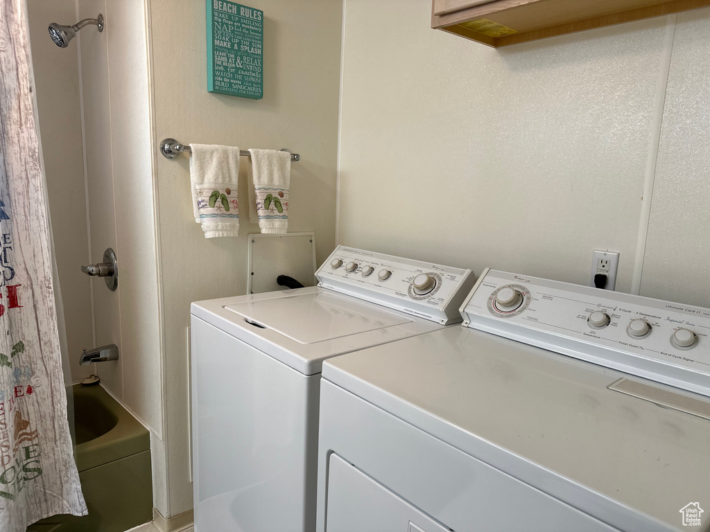 Laundry room with washer and clothes dryer