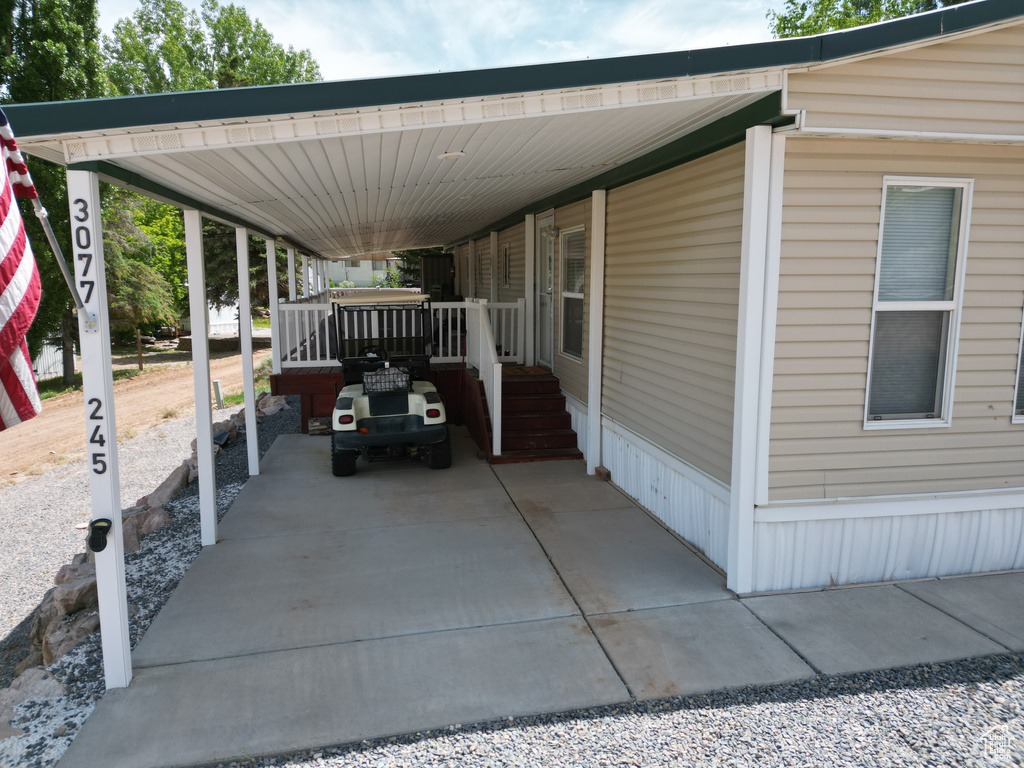 View of parking with an attached carport