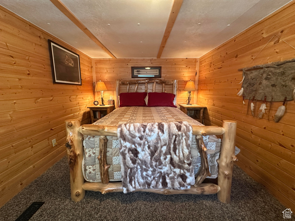 Bedroom featuring carpet and wooden walls
