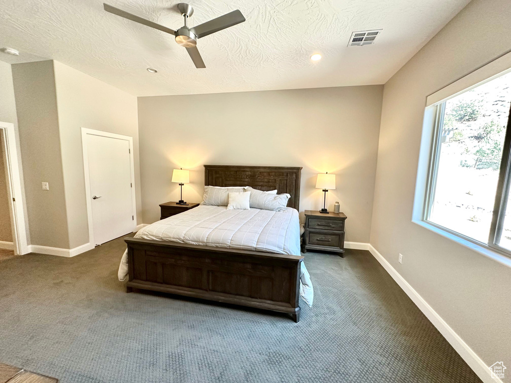 Carpeted bedroom featuring ceiling fan, recessed lighting, and a textured ceiling