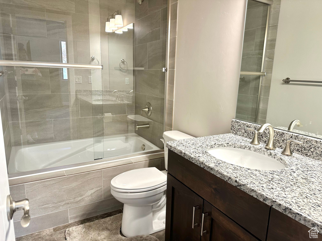 Full bath with tiled shower / bath combo and vanity