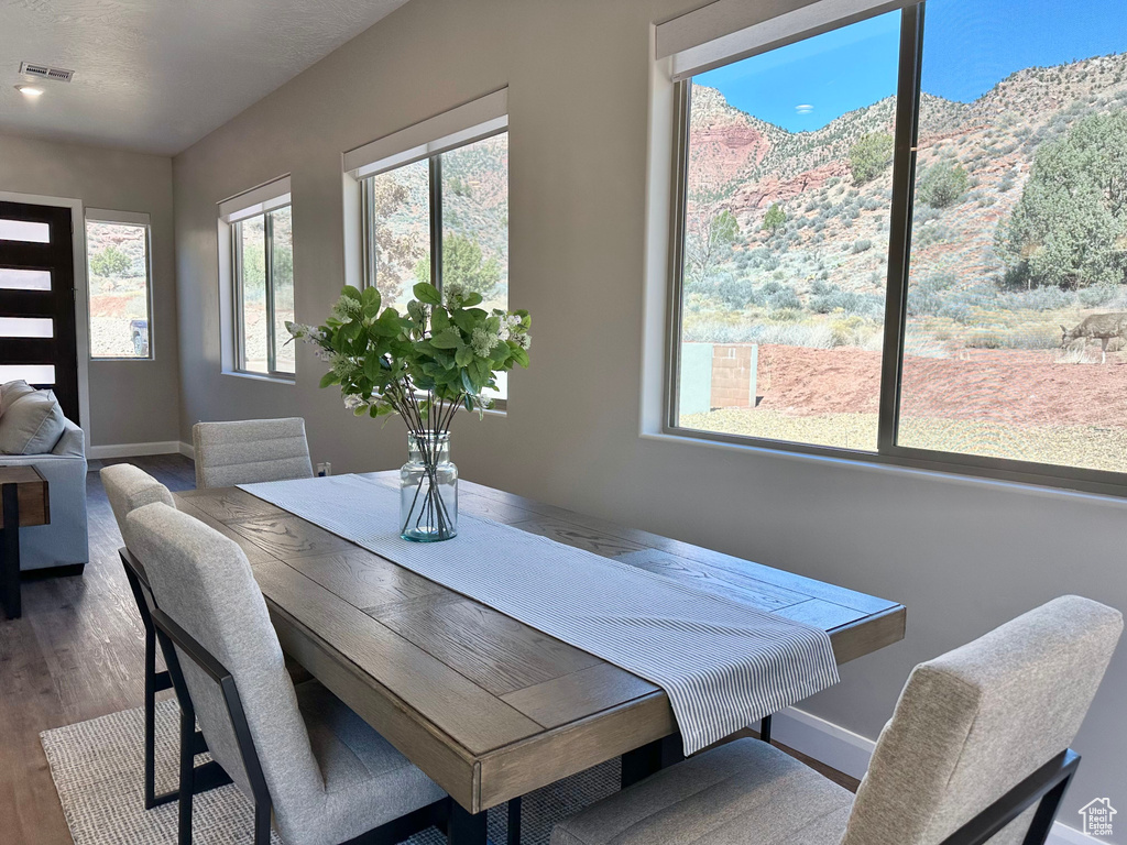 Dining room with wood finished floors and a mountain view