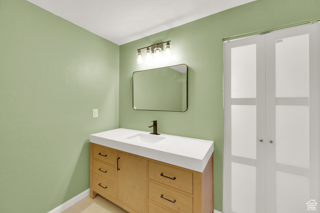 Bathroom featuring vanity and baseboards