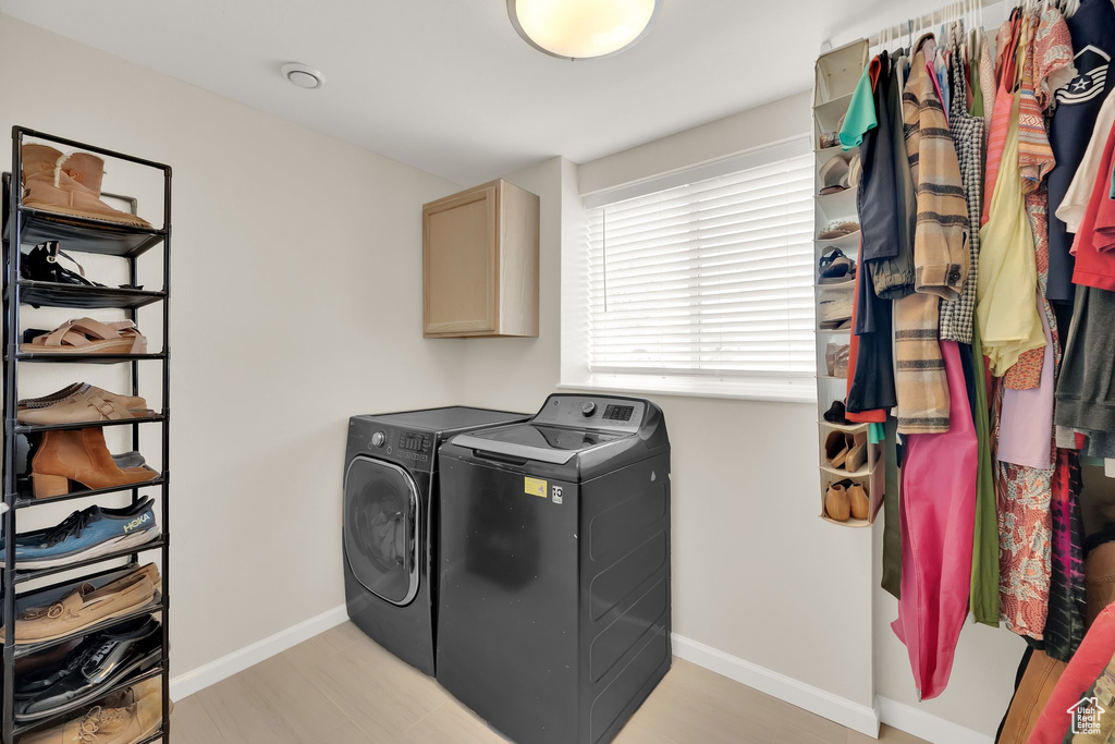 Washroom with separate washer and dryer and cabinet space