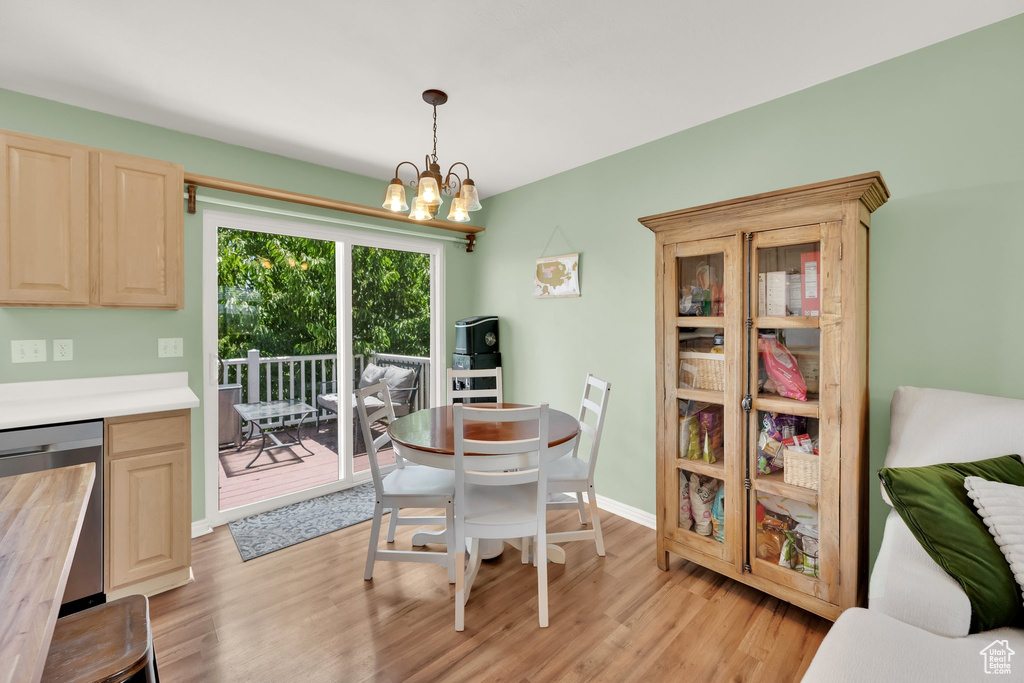 Dining area with a chandelier and light wood-style floors