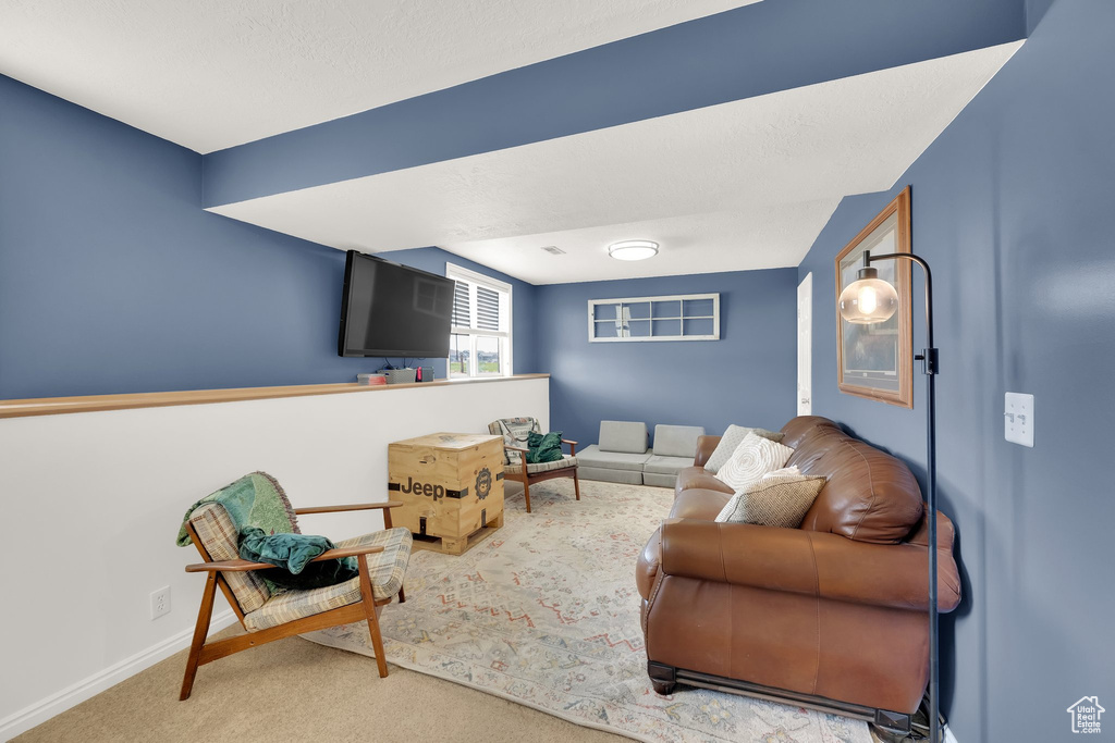 Carpeted living area with baseboards