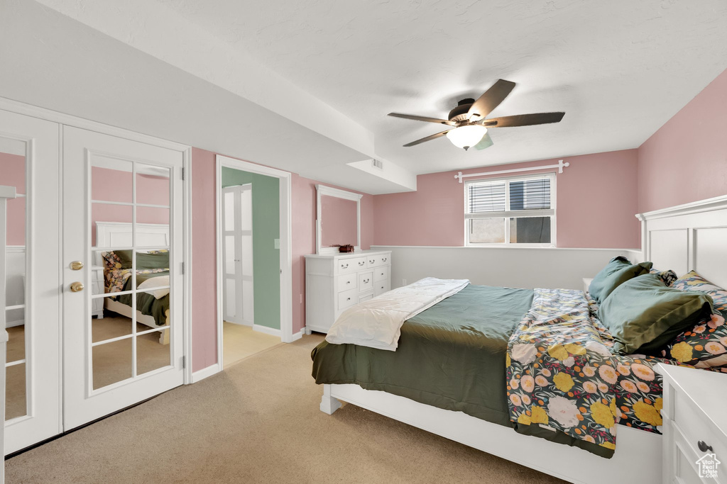 Bedroom featuring light carpet and ceiling fan