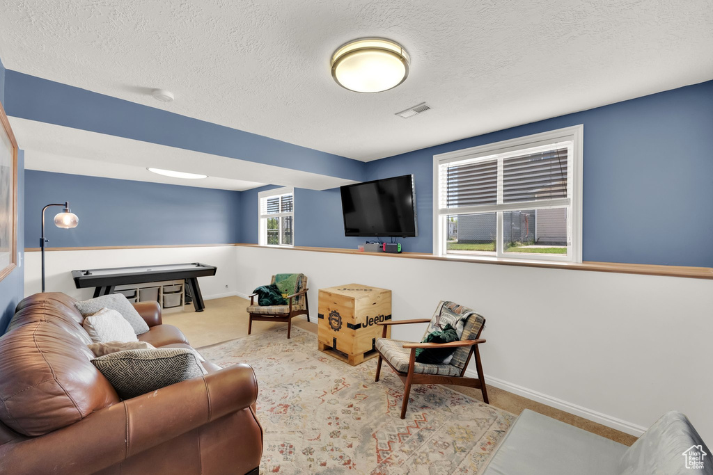 Living room featuring a textured ceiling and baseboards
