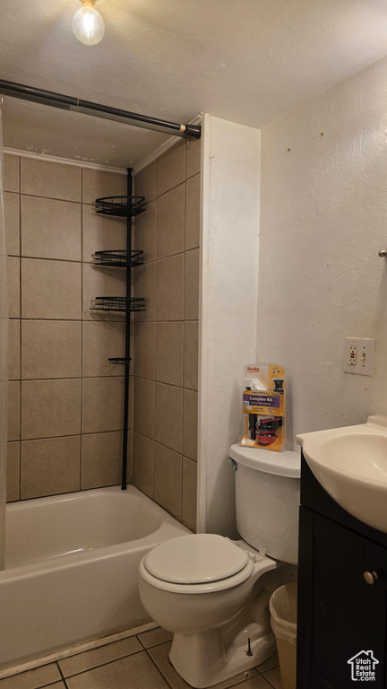 Full bathroom with tile patterned flooring, vanity, tub / shower combination, and a textured wall