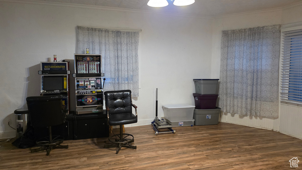 Home office featuring wood finished floors and ornamental molding