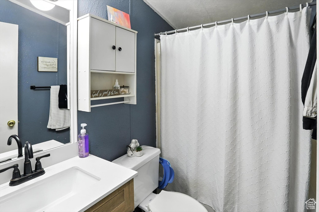 Bathroom with vanity and curtained shower