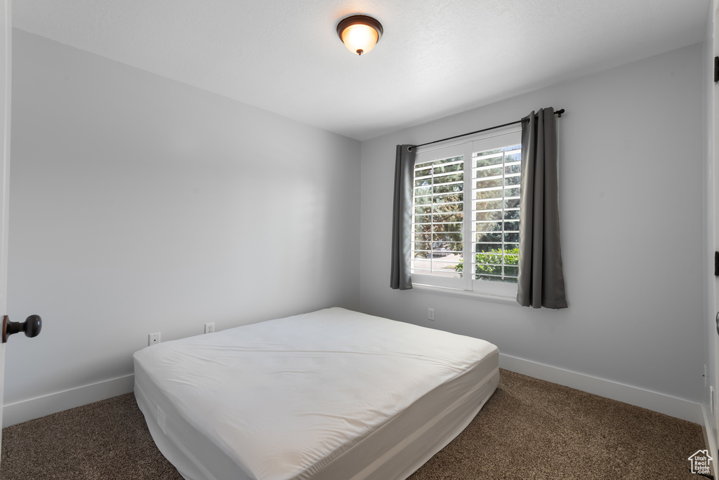Carpeted bedroom with baseboards