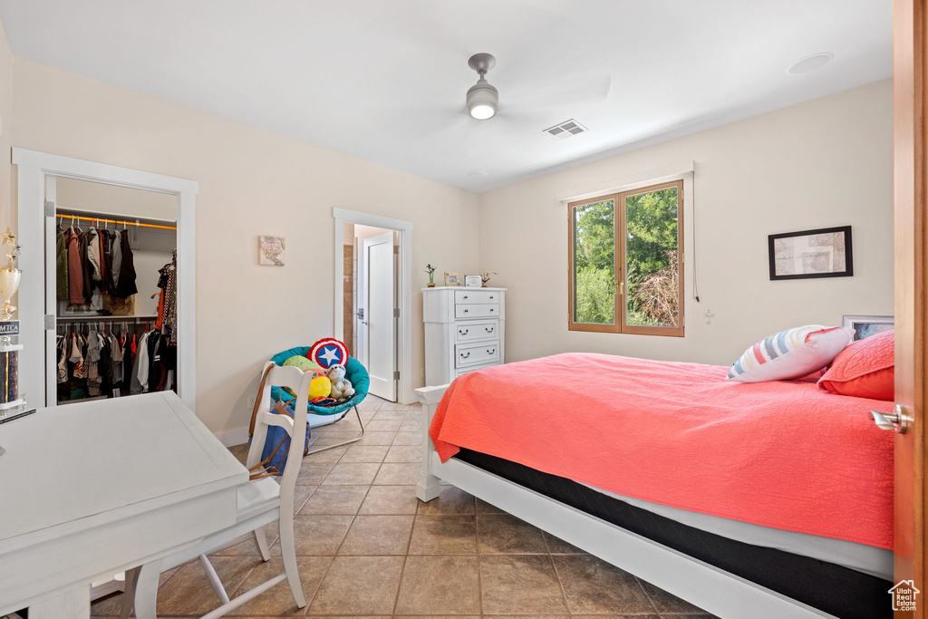 Bedroom with light tile patterned flooring, a walk in closet, and a closet