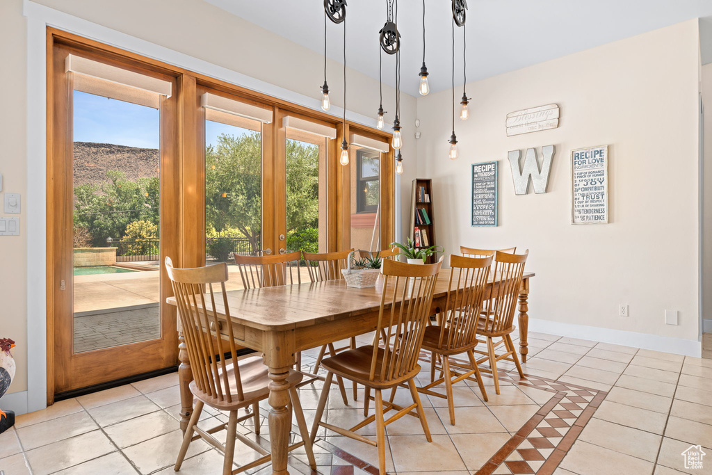 Dining area with light tile patterned floors